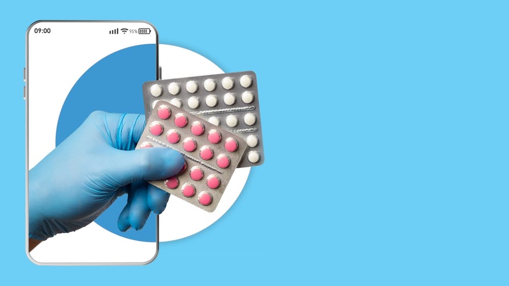 A mobile phone with prescription medications being held over it by a hand with medical gloves on