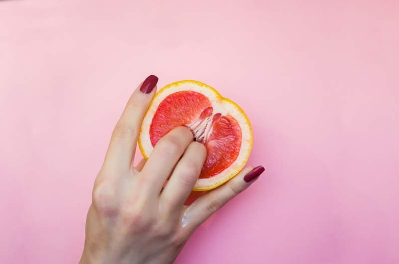 A female hand squeezing a grapefruit