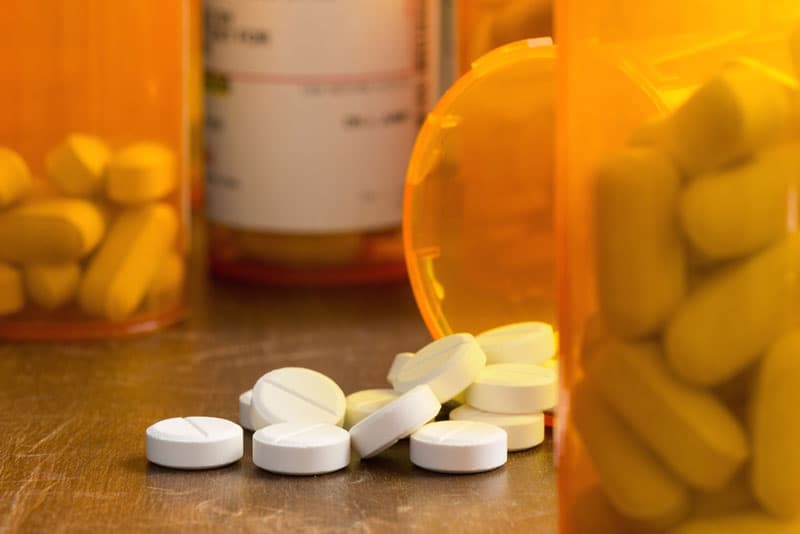 Painkillers spilling out from a container