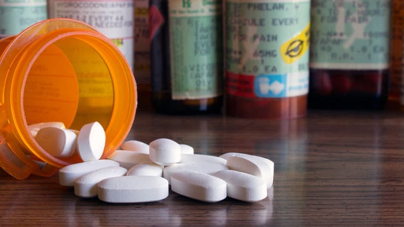 Codeine tablets spilling out from a jar