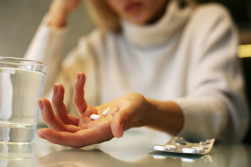 A hand holding amitriptyline tablets