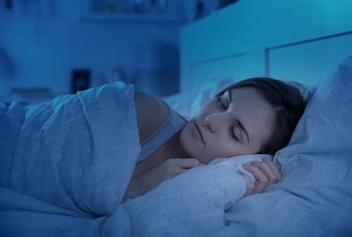 A lady sleeping in her bed