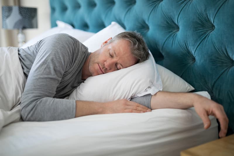 A man sleeping in his bed