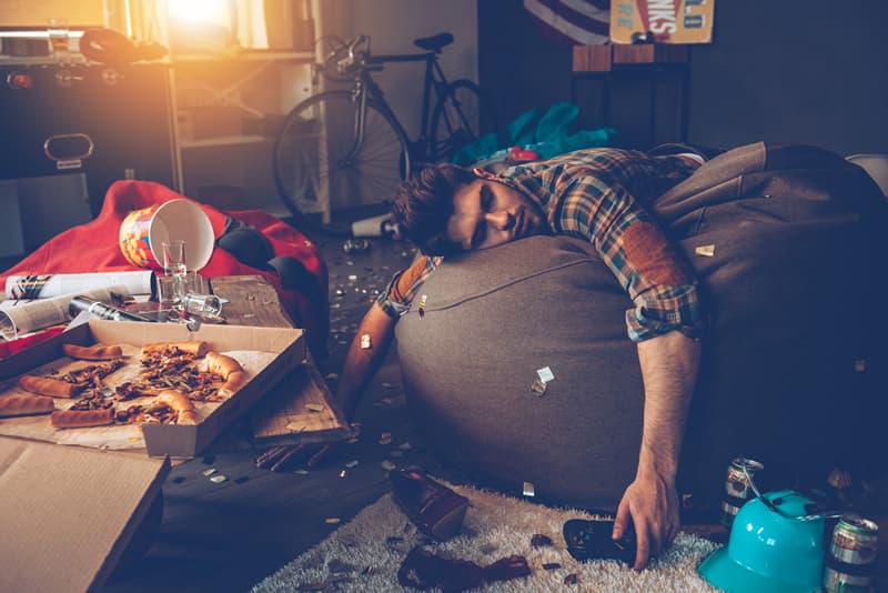 A male student passed out on a sofa due to drinking alcohol heavily