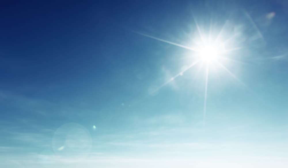 The sun shining in a blue sky