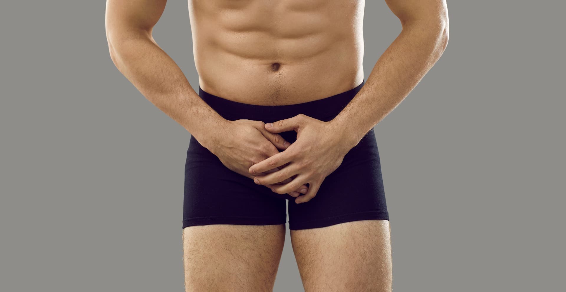 A man covering his crotch area