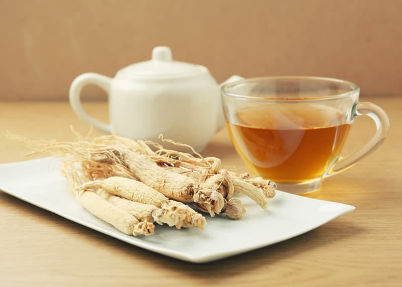 Ginseng next to some herbal tea