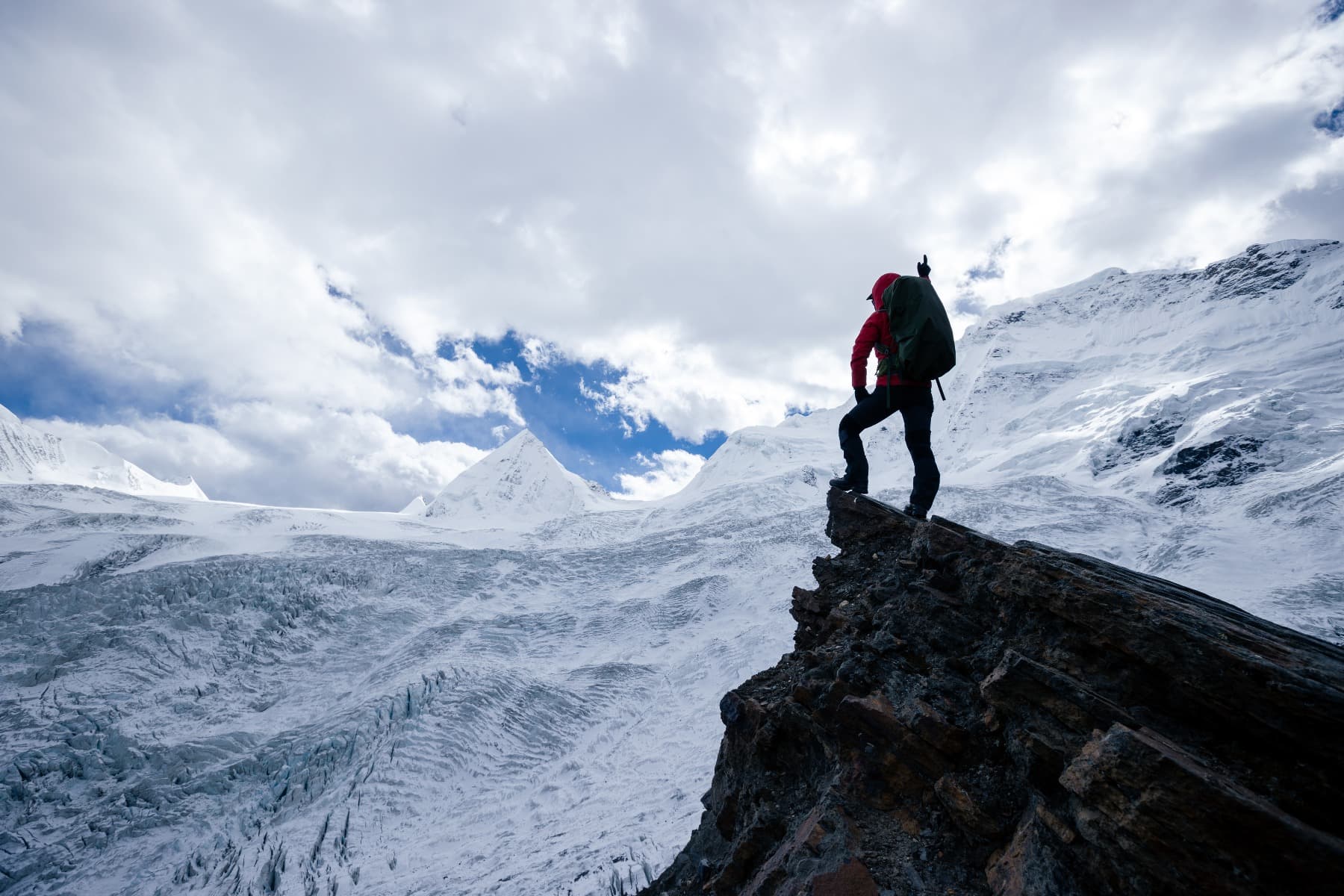 A man on top of a big mountain