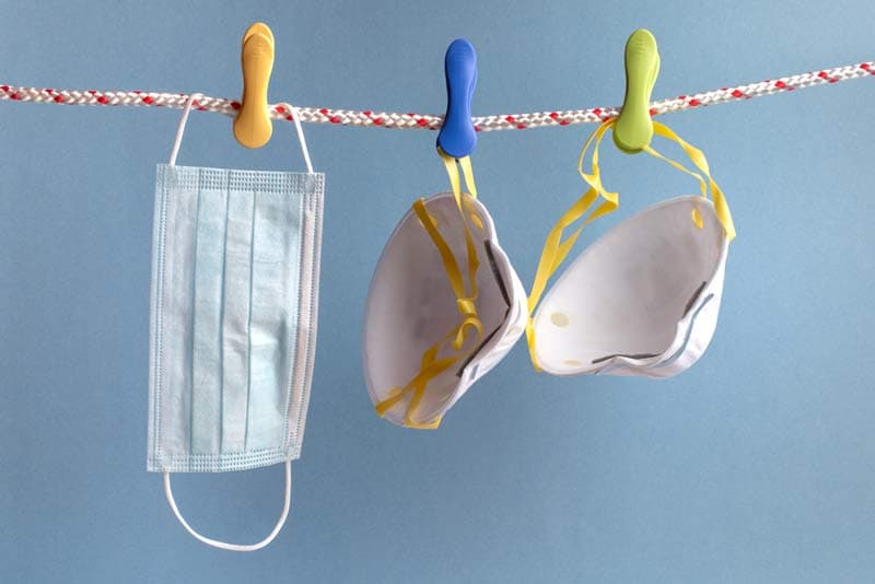 A selection of face masks hanging from a clothing line