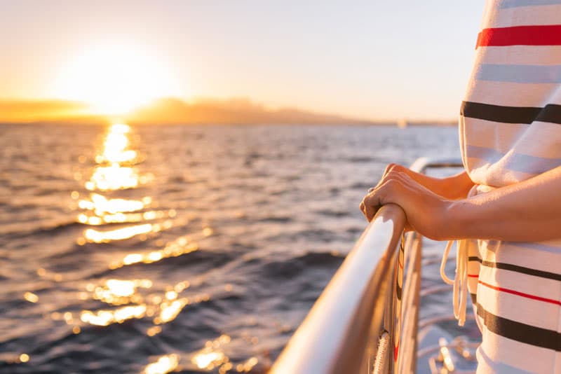 A person stood on the side of a boat