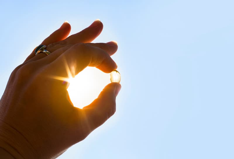 A hand pretending to hold the sun in it's fingers