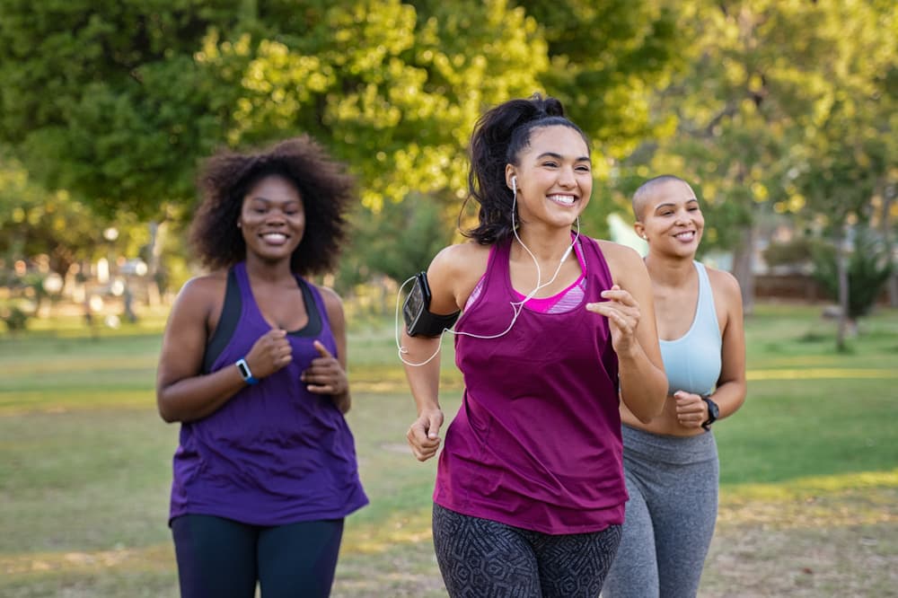 Three ladies running together in a park
