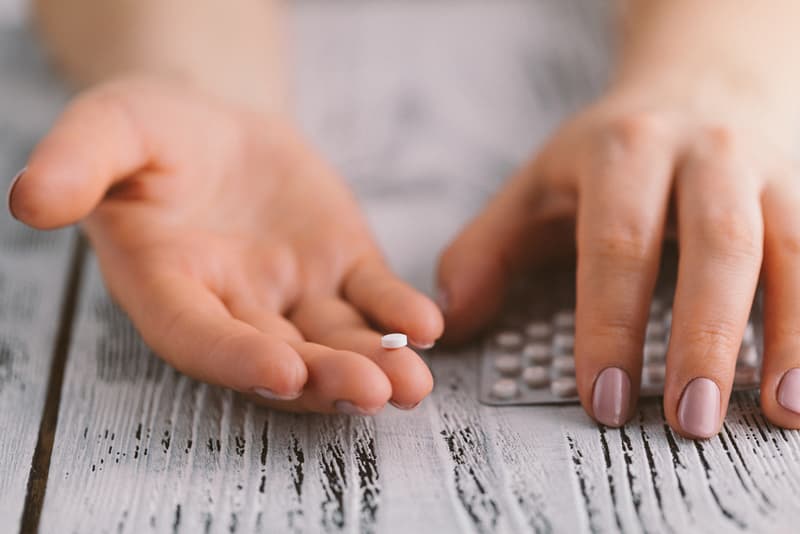 A hand holding an antibiotic tablet