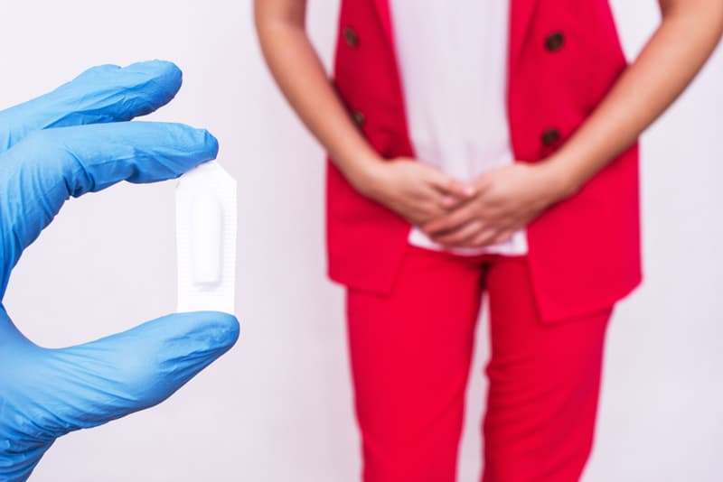 A lady covering her crotch with her hands