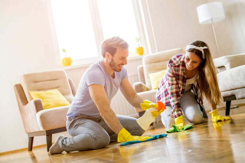 A couple cleaning their floor together
