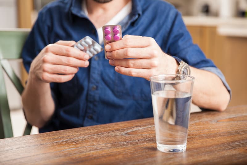 A person holding up two different ED medications