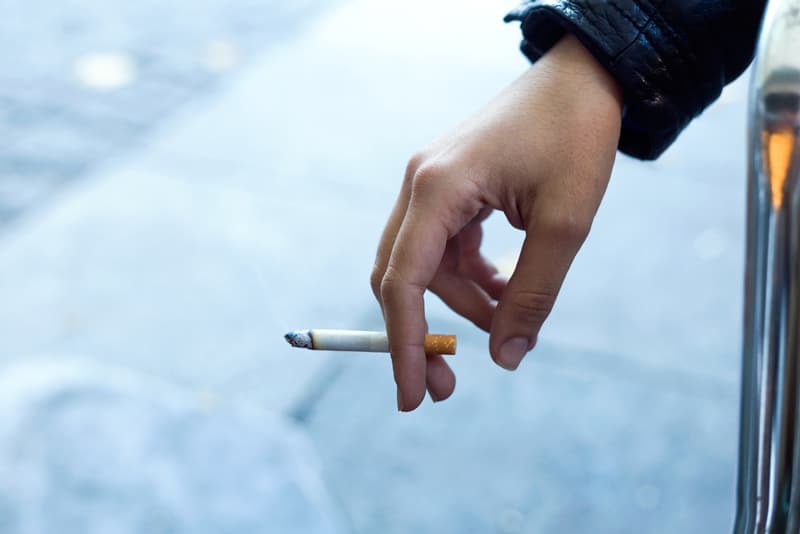 A hand holding a cigarette