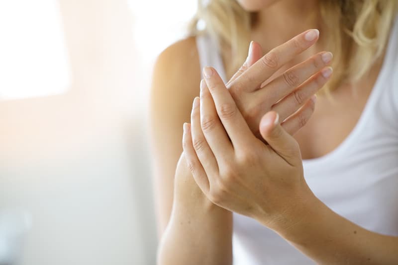 A lady feeling eczema on her hand