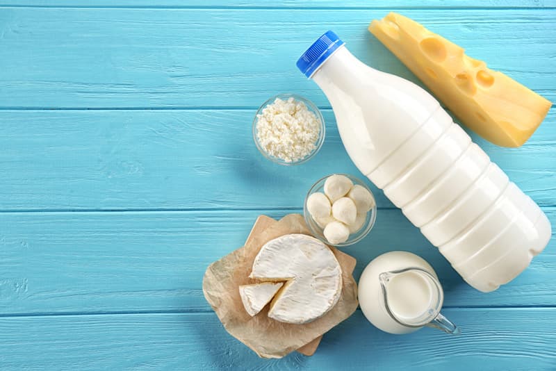 Various dairy food products spread out on a table