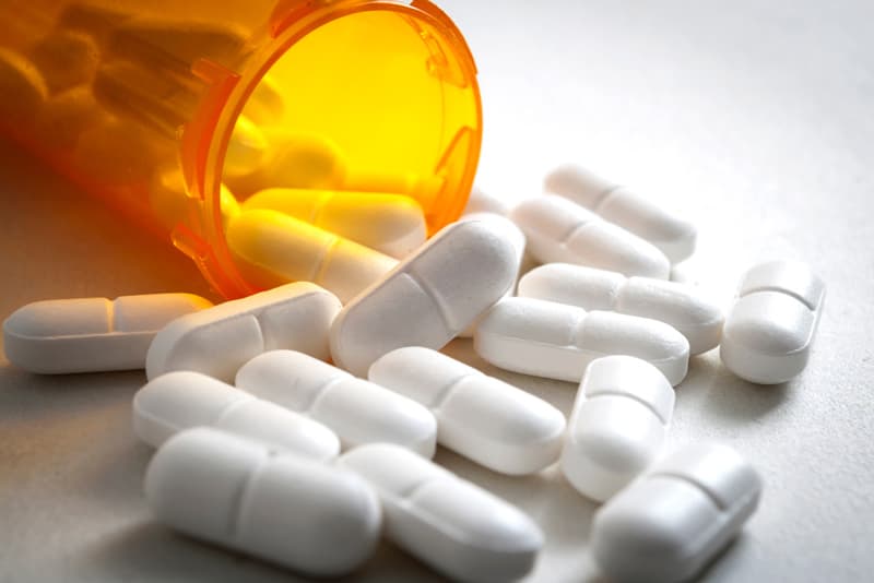 Naproxen tablets spilled out from a jar