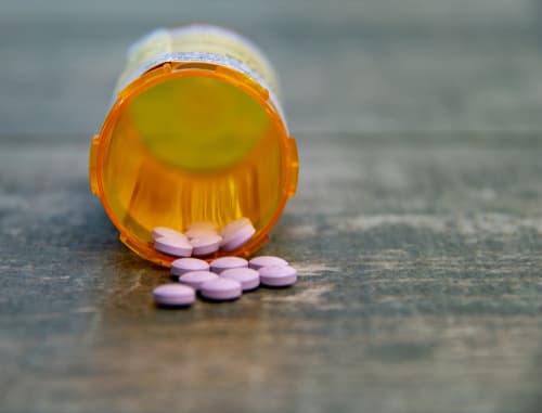 Zolpidem tablets spilling out of a har
