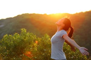 A lady doing yoga outdoors in the sun