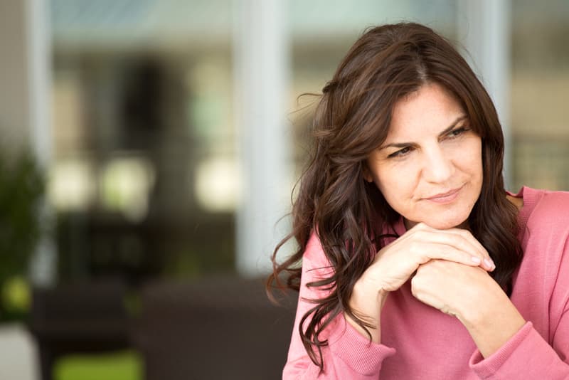A middle aged lady looking curiously into the distance