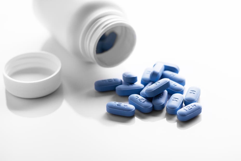 PrEP tablets spilling from a tub