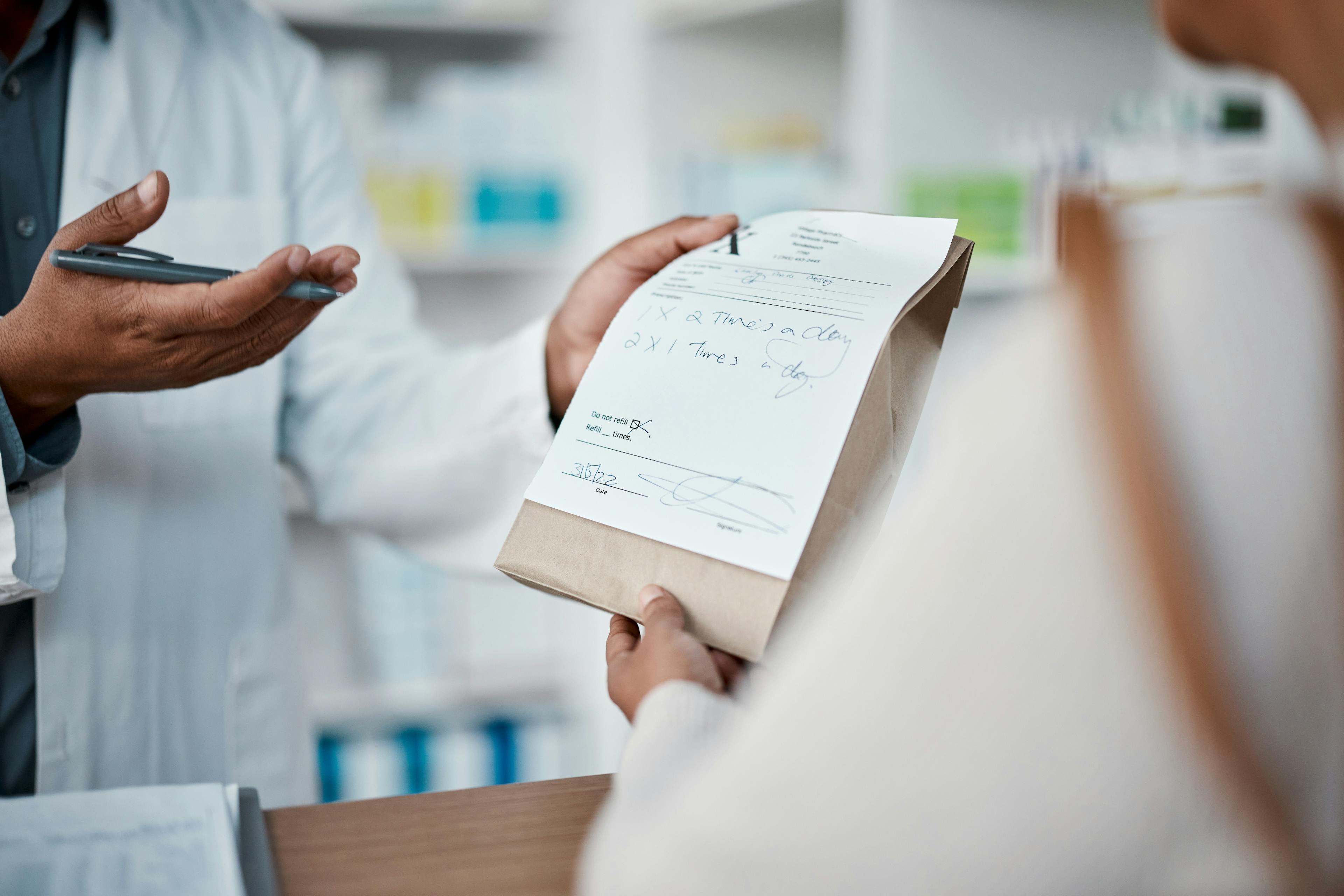 A pharmacist issuing a medical prescription to a patient