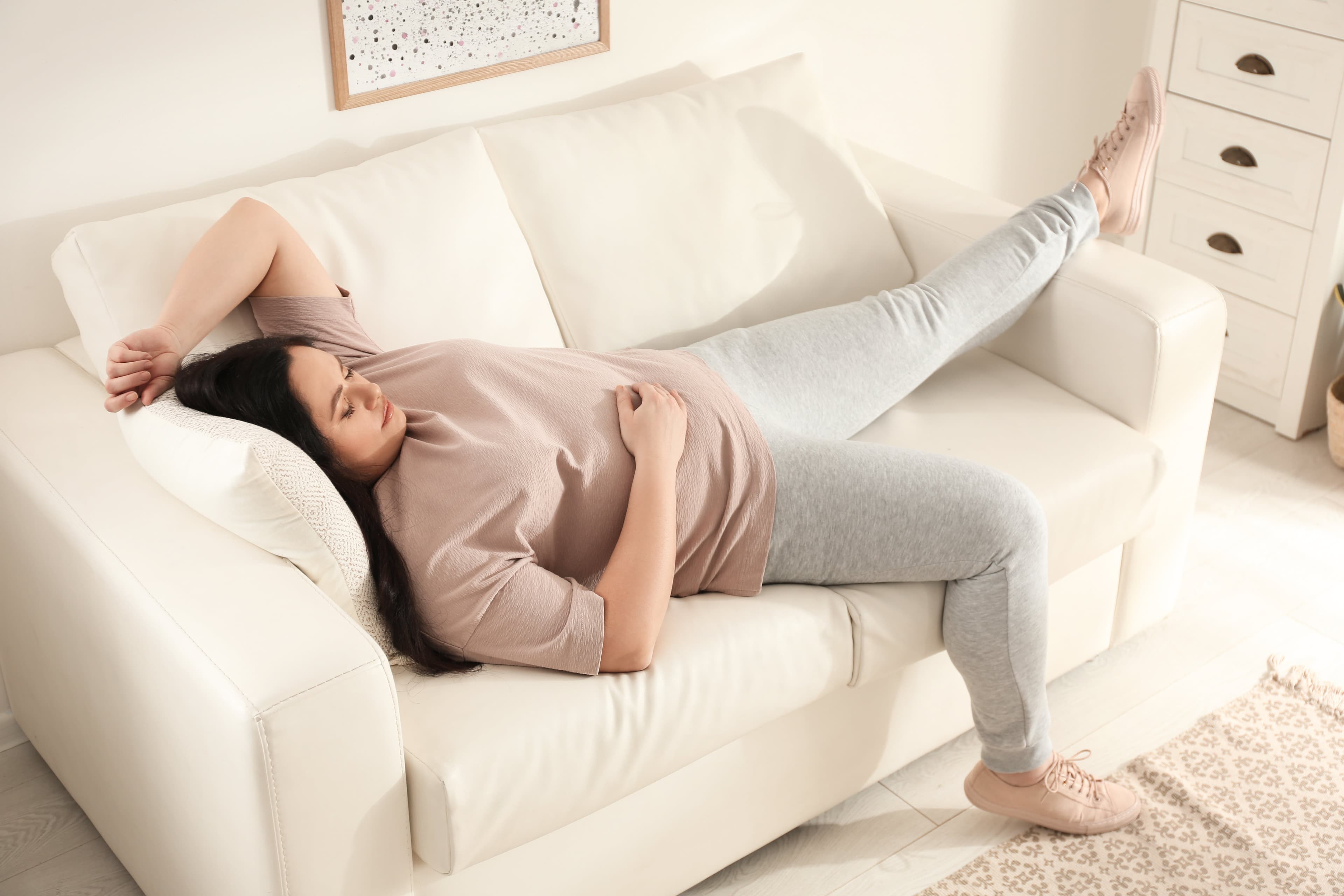 An overweight lady sleeping on her sofa