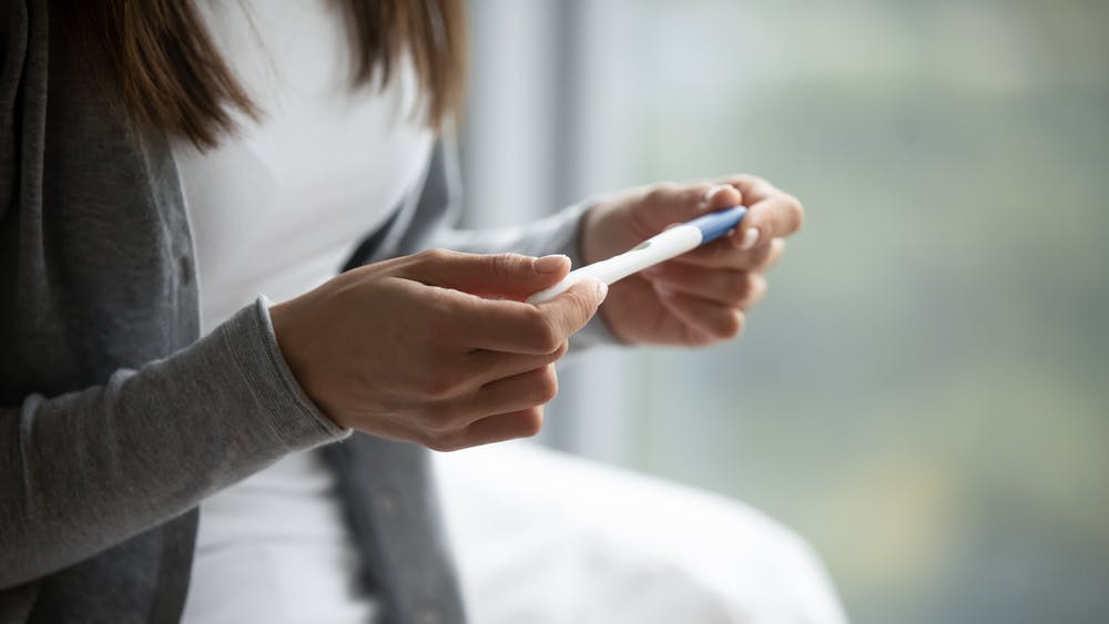 A woman checking a pregnancy test. 