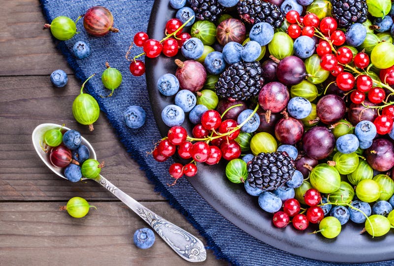 Berries on a plate next to a spoon
