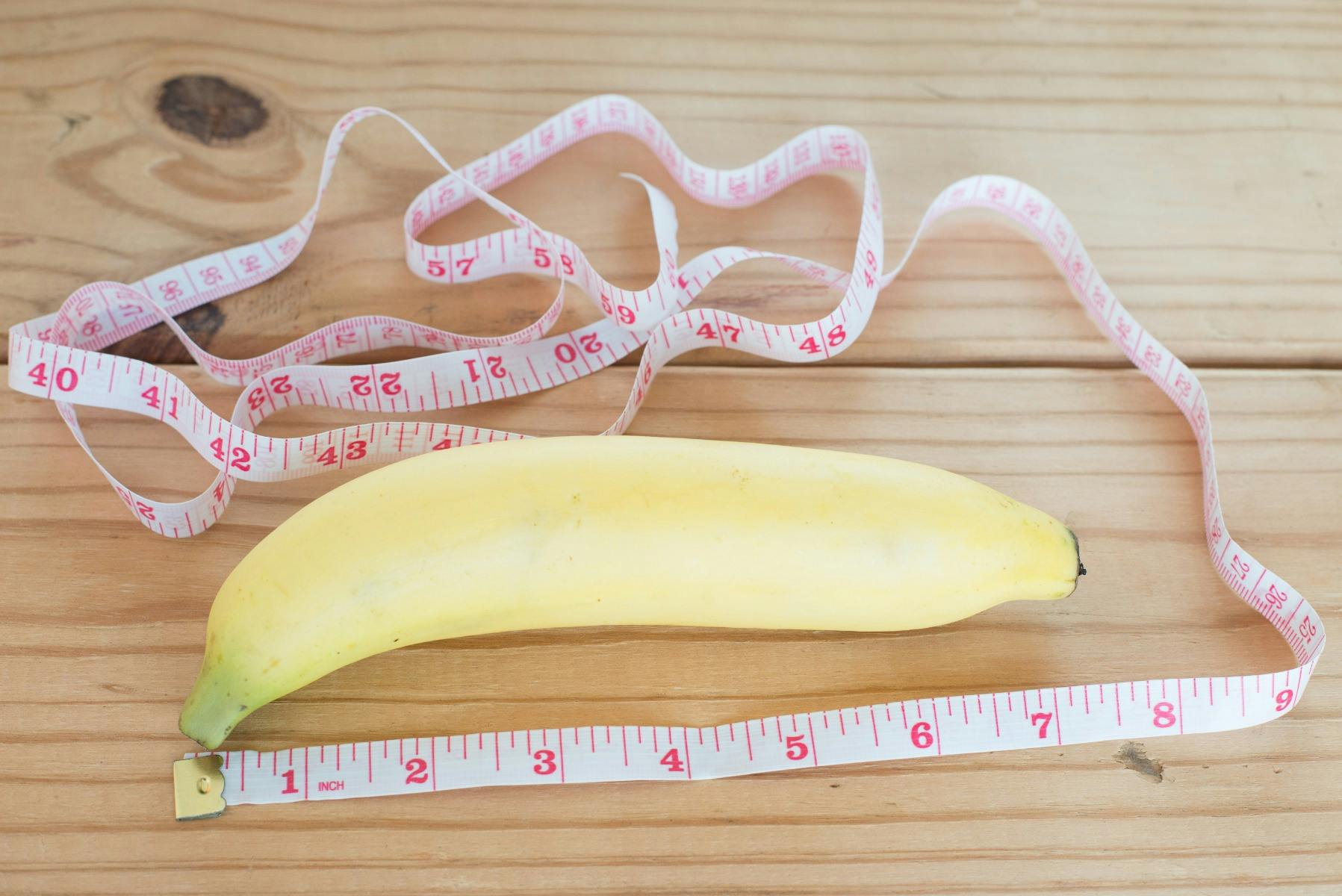 A banana with a tape measure around it to represent a penis