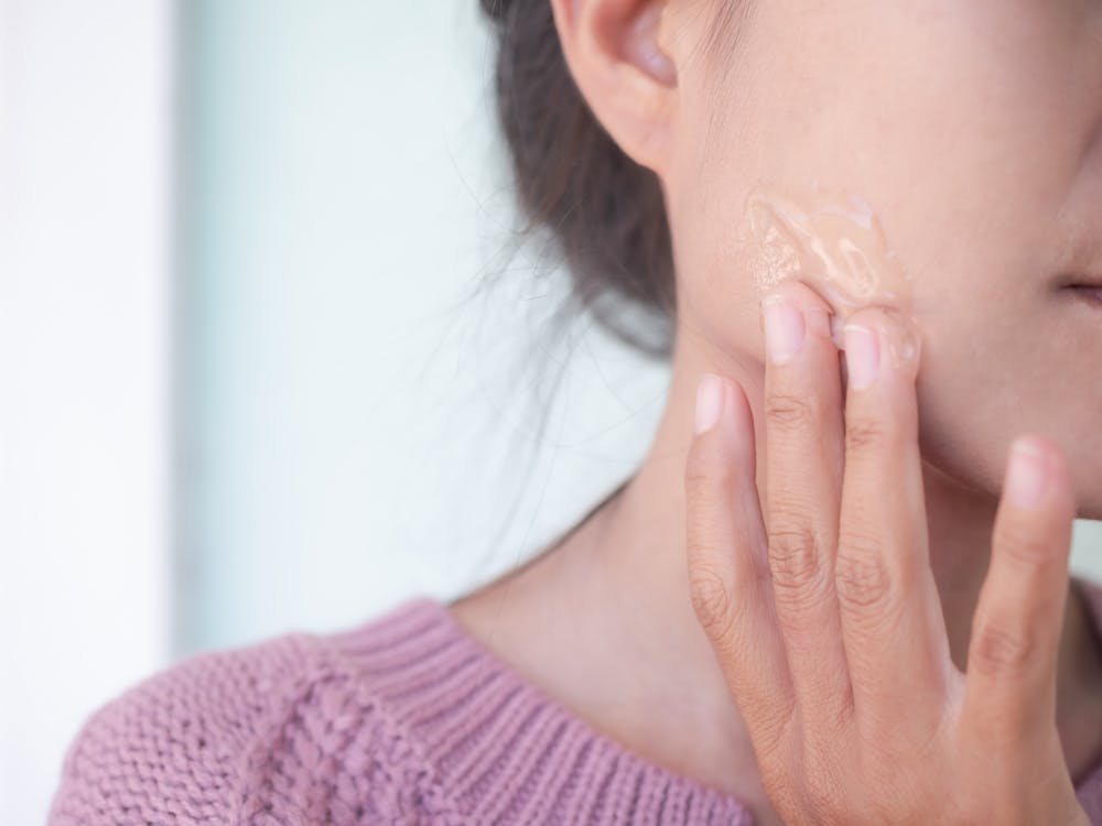 woman applying treclin gel on her face