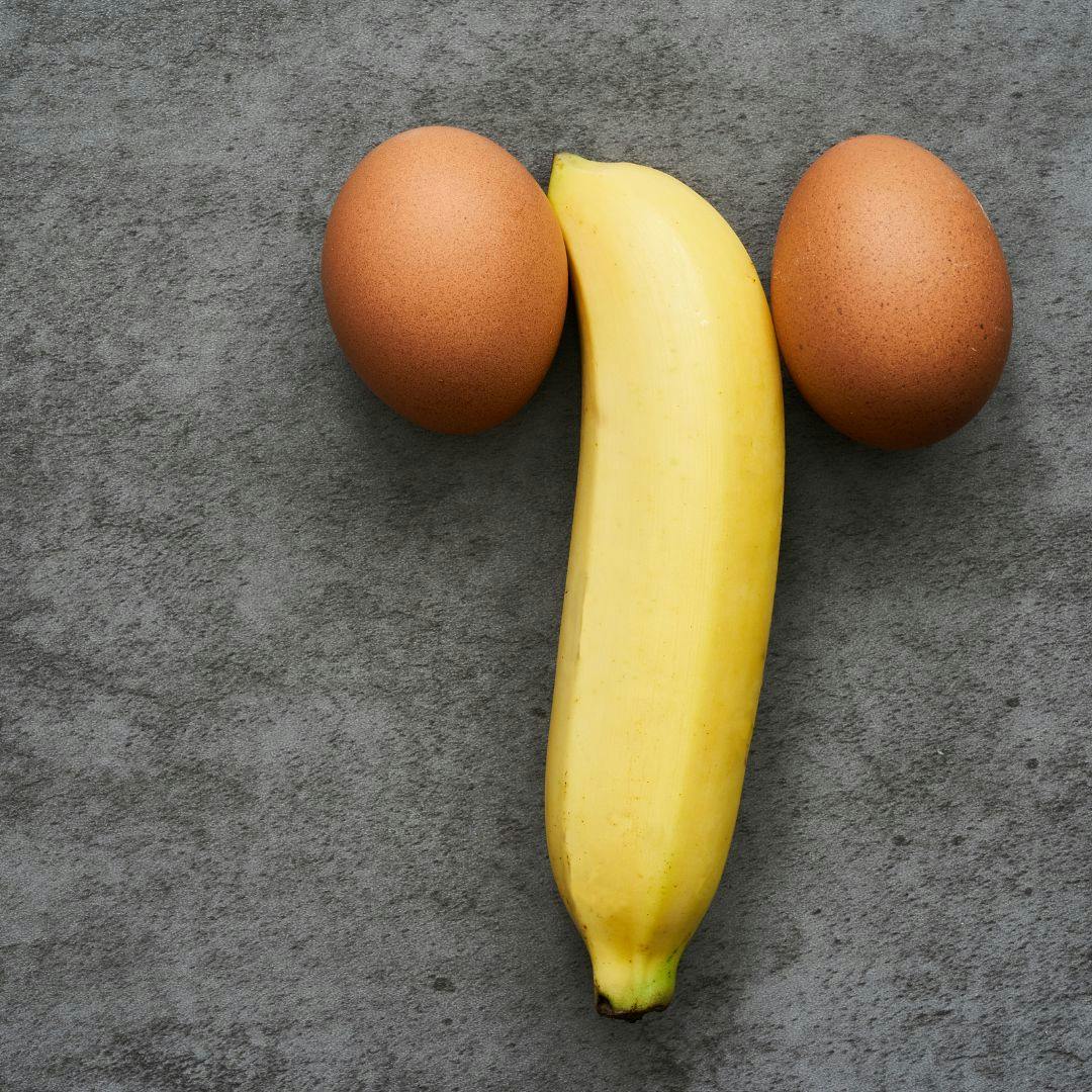 A banana and two eggs positioned to resemble a penis and testicles